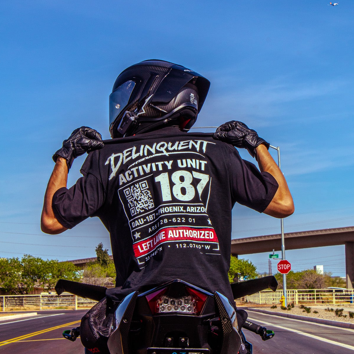 Rider holding up the MotoStreet DAU tee